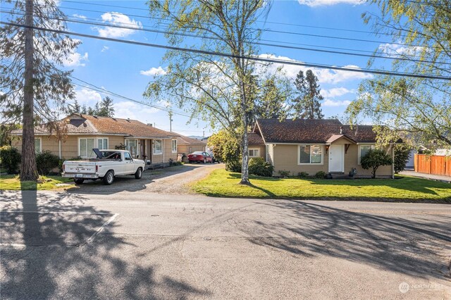 ranch-style home with a front lawn