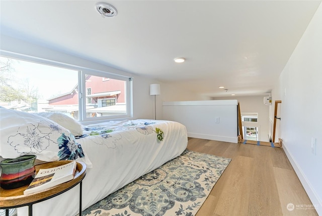bedroom featuring recessed lighting, light wood finished floors, and baseboards