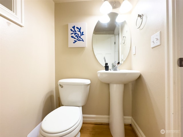 bathroom featuring hardwood / wood-style floors and toilet