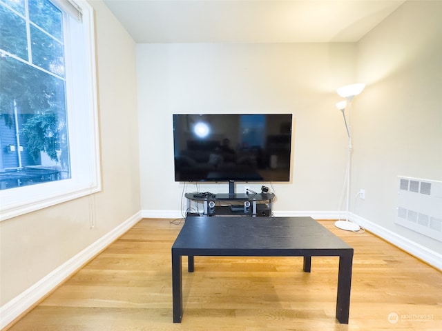 living room featuring wood-type flooring and radiator