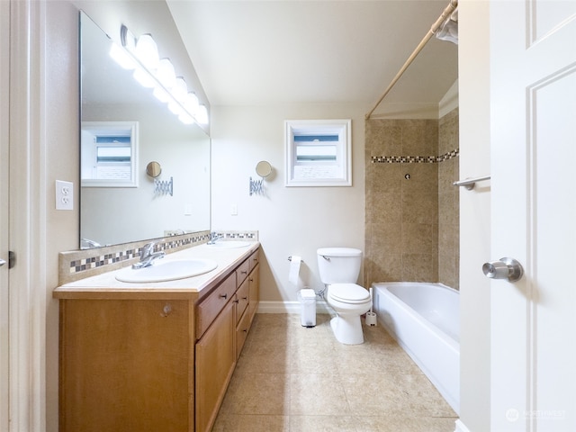 full bathroom featuring a wealth of natural light, tile flooring, tiled shower / bath combo, large vanity, and toilet