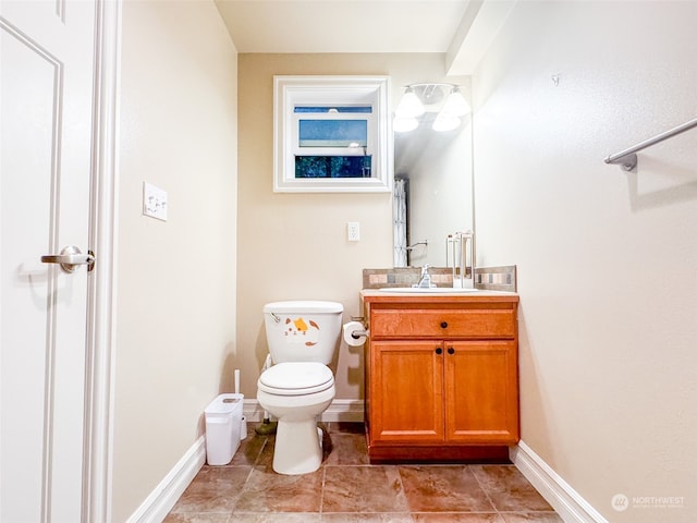 bathroom featuring tile floors, oversized vanity, and toilet