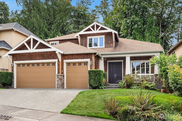 craftsman-style house featuring a front yard and a garage