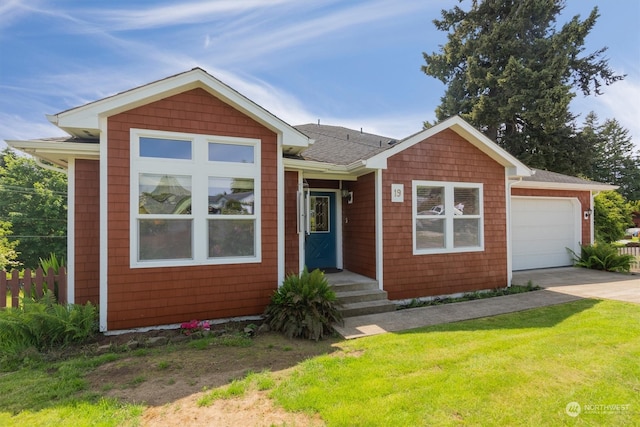 view of front of home with a front yard and a garage