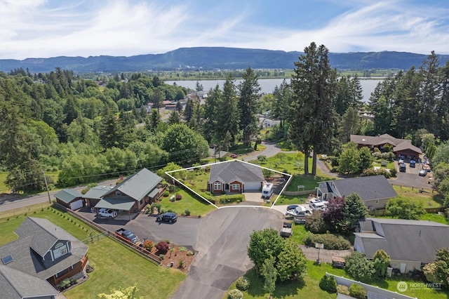 birds eye view of property featuring a water and mountain view