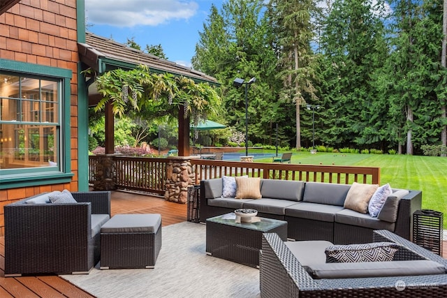 wooden deck featuring outdoor lounge area and a yard