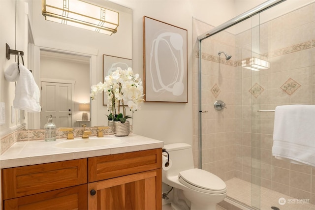 bathroom featuring vanity, an enclosed shower, and toilet