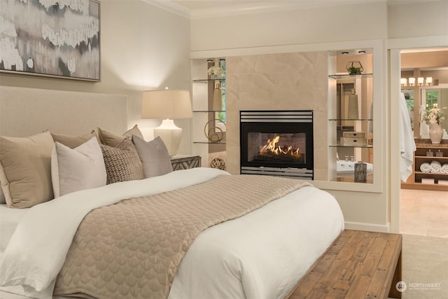 bedroom featuring a tile fireplace, crown molding, and wood-type flooring