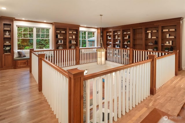 staircase with crown molding and hardwood / wood-style flooring