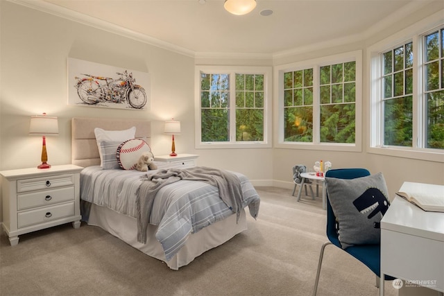 bedroom featuring crown molding and light carpet