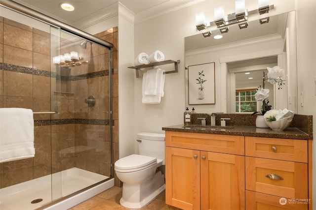 bathroom with vanity, crown molding, tile patterned flooring, toilet, and an enclosed shower