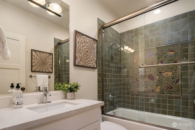 full bathroom with toilet, vanity, and combined bath / shower with glass door