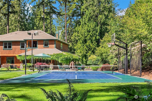 view of basketball court with tennis court and a lawn