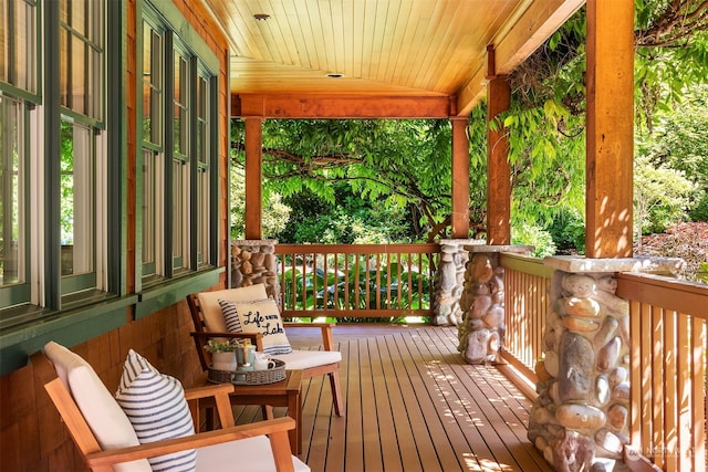 wooden terrace featuring covered porch