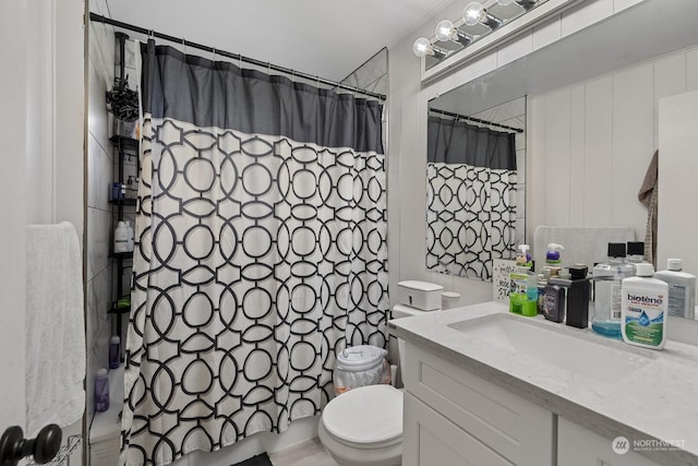 bathroom featuring vanity, a shower with shower curtain, and toilet