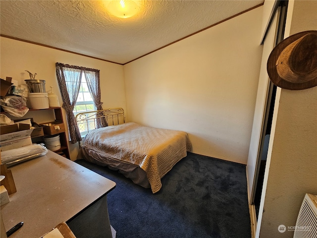 carpeted bedroom featuring a textured ceiling