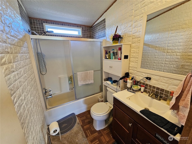 full bathroom with brick wall, combined bath / shower with glass door, parquet floors, toilet, and vanity