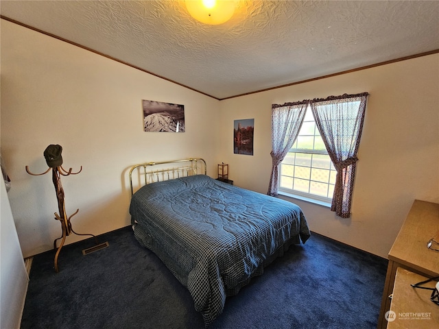 bedroom with a textured ceiling, lofted ceiling, and dark colored carpet