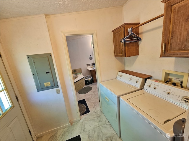 washroom with washer hookup, a textured ceiling, light tile floors, washer and clothes dryer, and cabinets