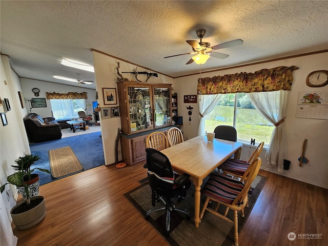 dining space featuring crown molding, ceiling fan, wood finished floors, and vaulted ceiling