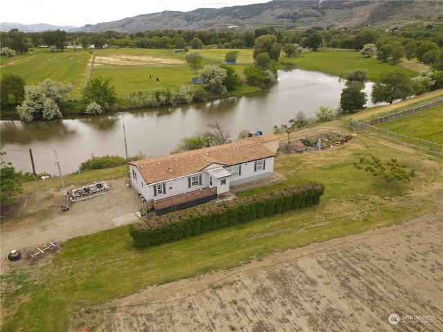 aerial view featuring a water and mountain view and a rural view