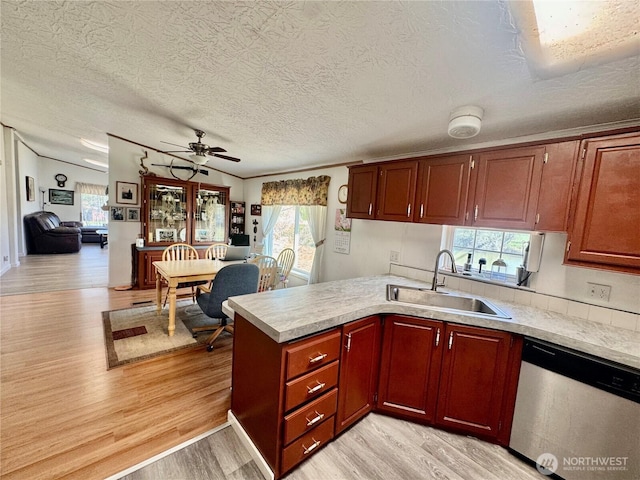 12 Moonlight Dr, Oroville, WA 98844 - kitchen with a sink, dishwasher, light countertops, a peninsula, and a textured ceiling