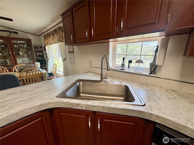 12 Moonlight Dr, Oroville, WA 98844 - kitchen with a sink, light countertops, a textured ceiling, lofted ceiling, and tasteful backsplash