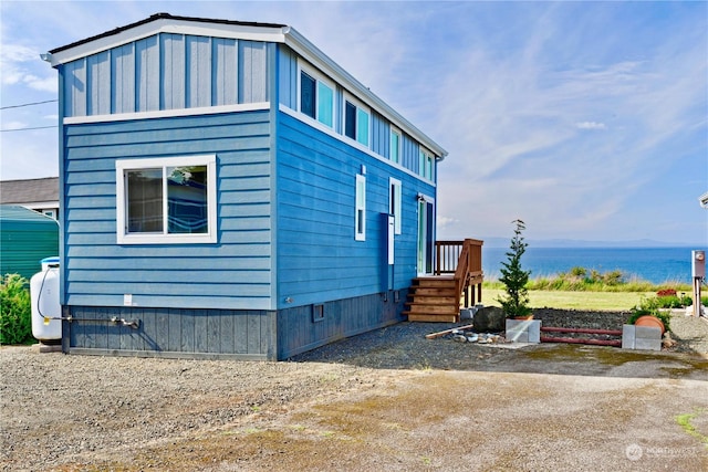 view of side of home featuring a water view