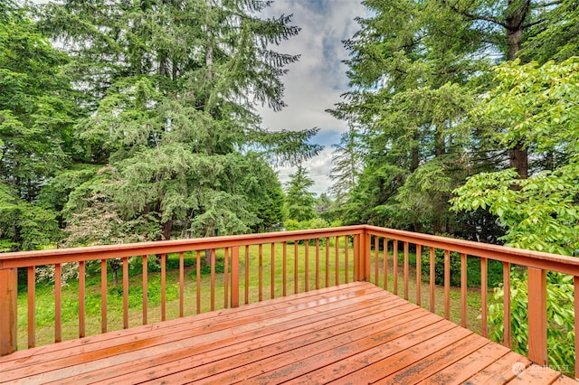 wooden terrace with a yard