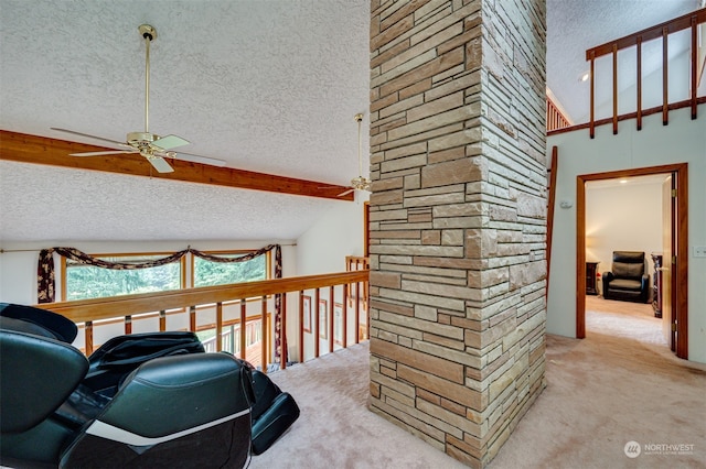 interior space with a textured ceiling, carpet flooring, lofted ceiling, and ceiling fan