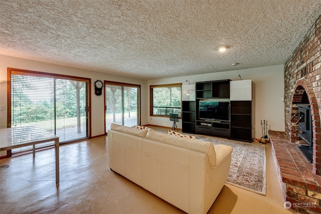 unfurnished living room featuring brick wall, a brick fireplace, and a textured ceiling