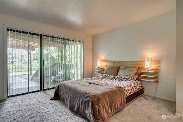 carpeted bedroom featuring access to outside