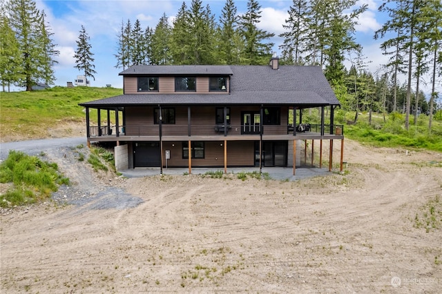 exterior space with a wooden deck and a garage