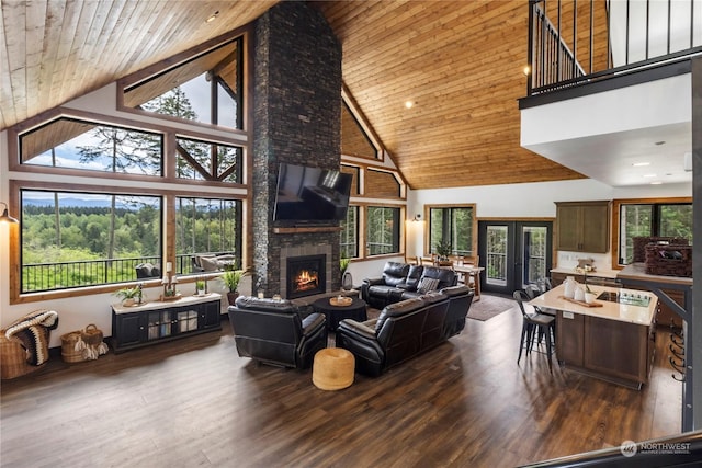 living room with a healthy amount of sunlight, wood ceiling, a fireplace, and high vaulted ceiling