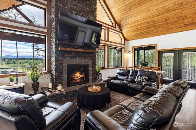 living room featuring a wealth of natural light, high vaulted ceiling, and wood ceiling