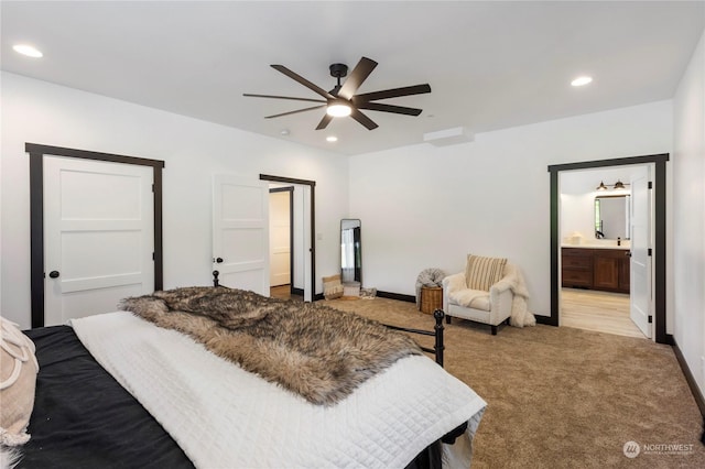 carpeted bedroom with connected bathroom and ceiling fan