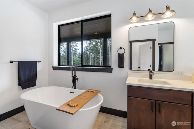 bathroom with vanity, tile patterned floors, and a bathtub