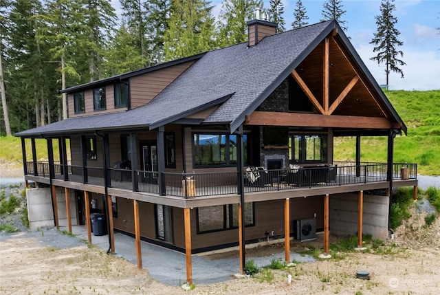 back of house with a fireplace and ac unit