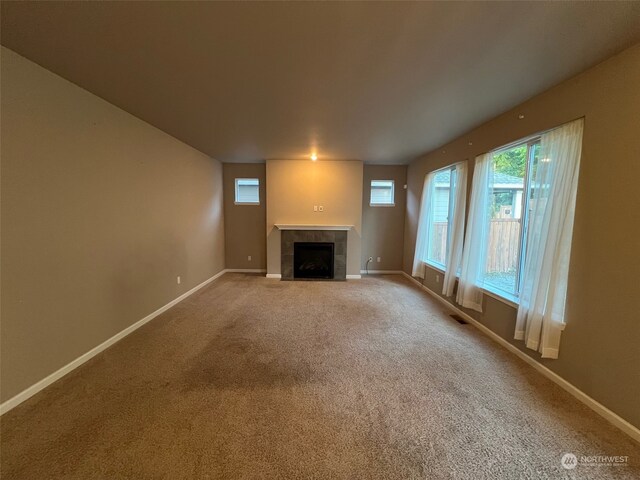 8701 29th Way SE, Olympia, WA 98513 - unfurnished living room featuring a tiled fireplace and carpet