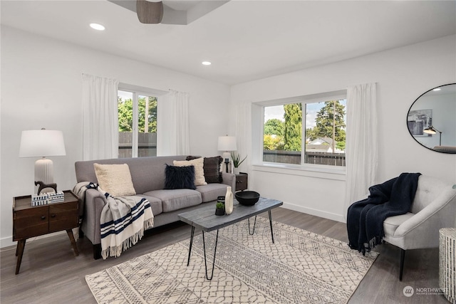 living room featuring a wealth of natural light, ceiling fan, and wood-type flooring