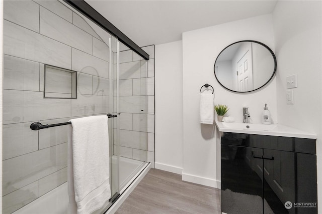 bathroom with vanity, hardwood / wood-style flooring, and an enclosed shower