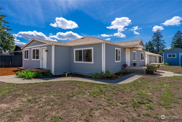 view of front of property with a storage shed and a front yard