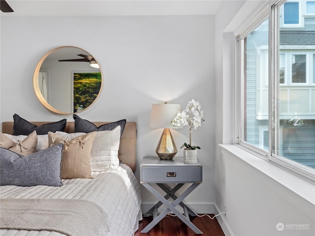 bedroom with wood-type flooring and multiple windows