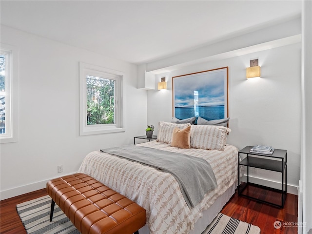 bedroom with dark hardwood / wood-style floors