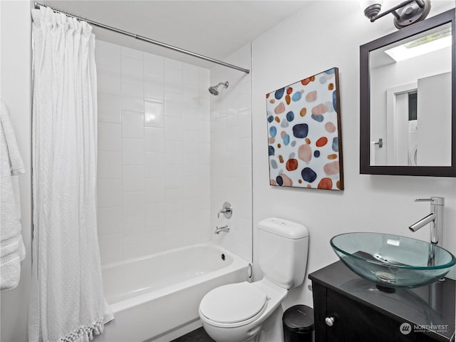 full bathroom featuring shower / bath combination with curtain, vanity, and toilet