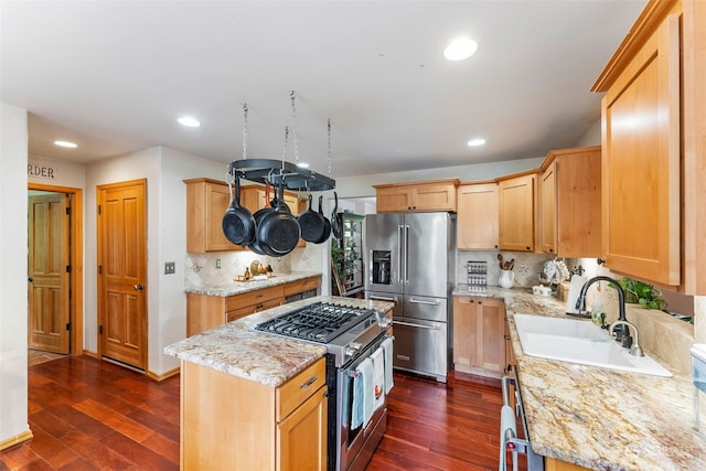 kitchen with dark wood-style flooring, tasteful backsplash, appliances with stainless steel finishes, and a sink