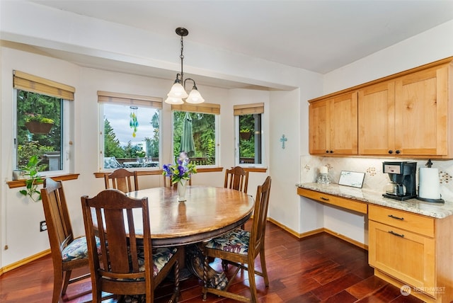 dining space with built in study area, dark wood finished floors, and baseboards