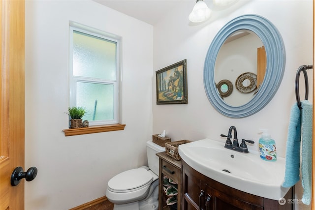 half bathroom featuring toilet and vanity