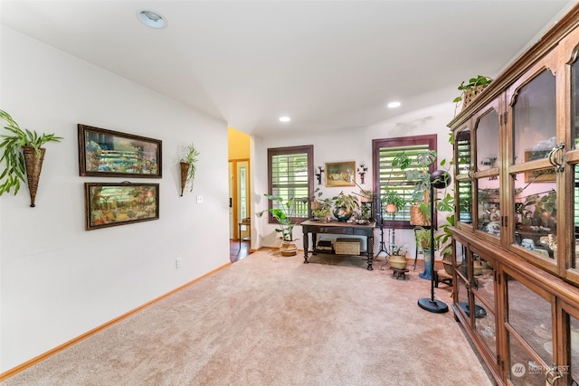 interior space featuring light colored carpet, baseboards, and recessed lighting