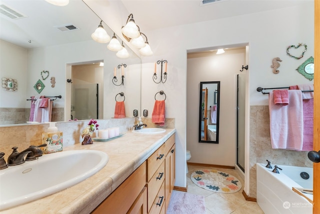full bathroom with visible vents, a shower stall, and a sink